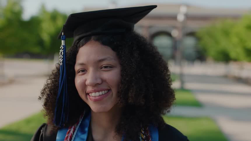 Portrait of a smiling woman wearing a graduation cap and gown