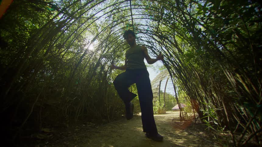 Man has a natural tunnel formed by dancing tree branches