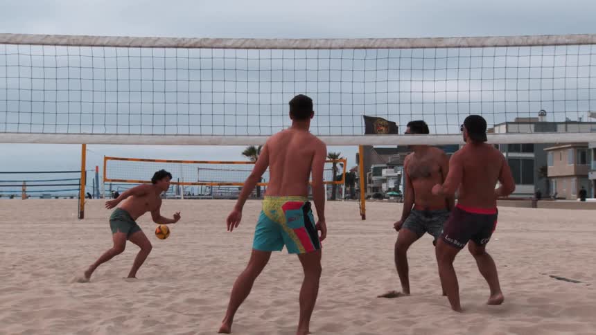 Two guys winning a play at beach volleyball on the sand