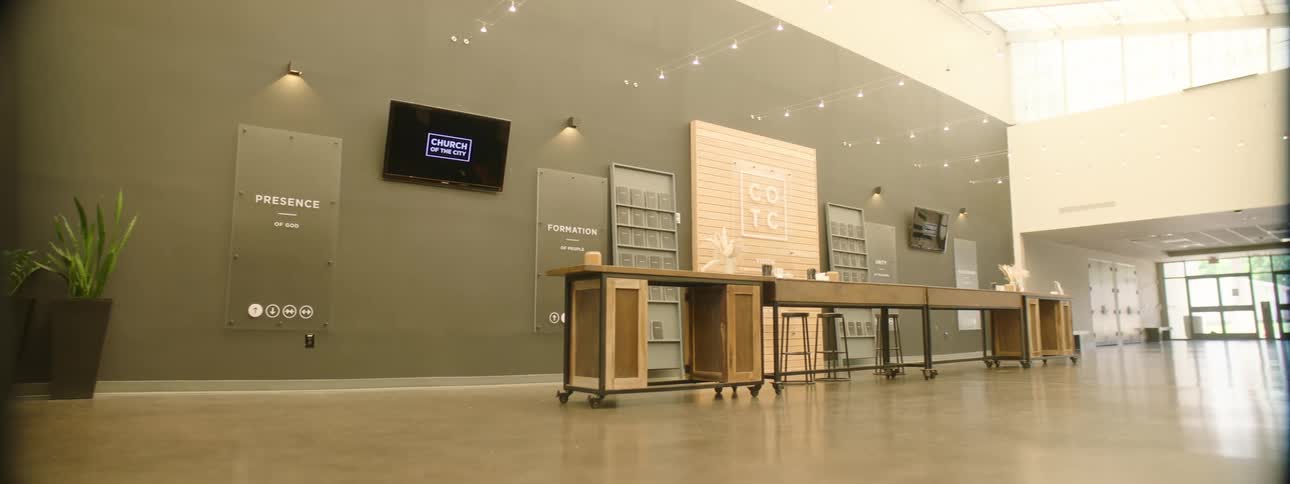 Spacious modern interior with a reception that includes contemporary monitors and furniture