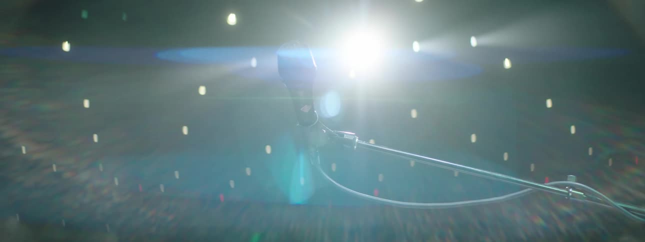A microphone on a stage illuminated by a strong white light