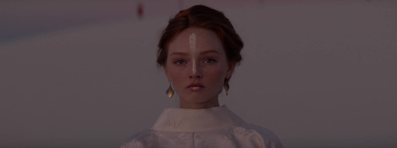 Portrait of a woman wearing white clothes with a serious facial expression in a natural environment with desert dunes in the background
