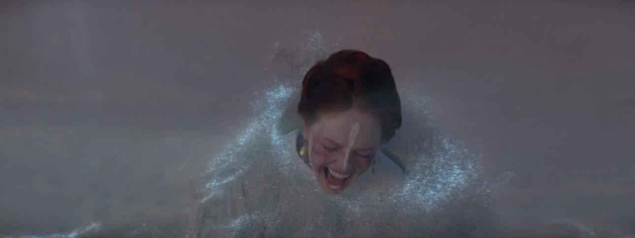 A woman screams as glowing dust moves all over her
