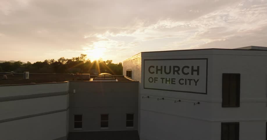 The sun shines on a large church building