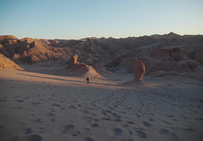 Desert canyons and dunes environment with a person walking