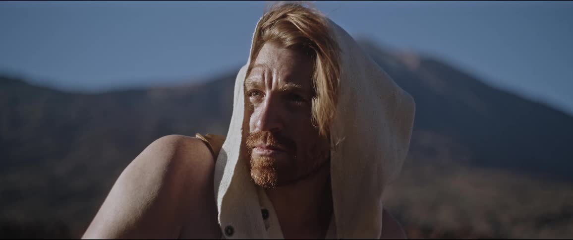 A man with red hair and red beard surveys his surroundings