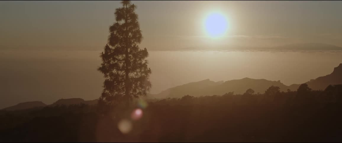 Stunning sunset with the sun radiating light over mountains