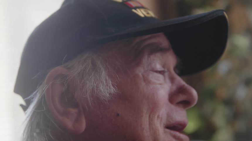 Close up of the face of a happy elderly man with teary eyes remembering the past