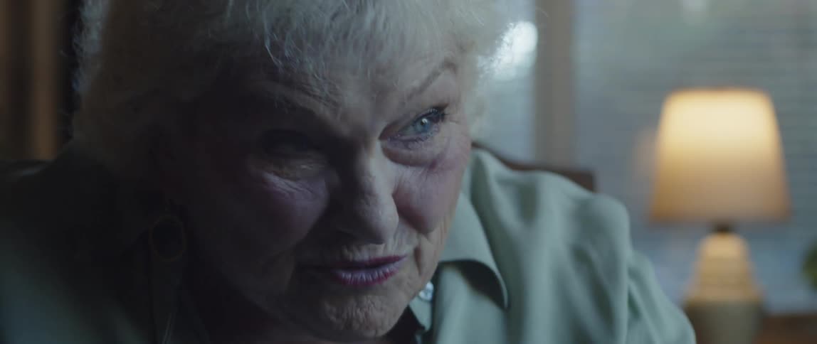 Closeup on the face of an elderly woman sitting and talking