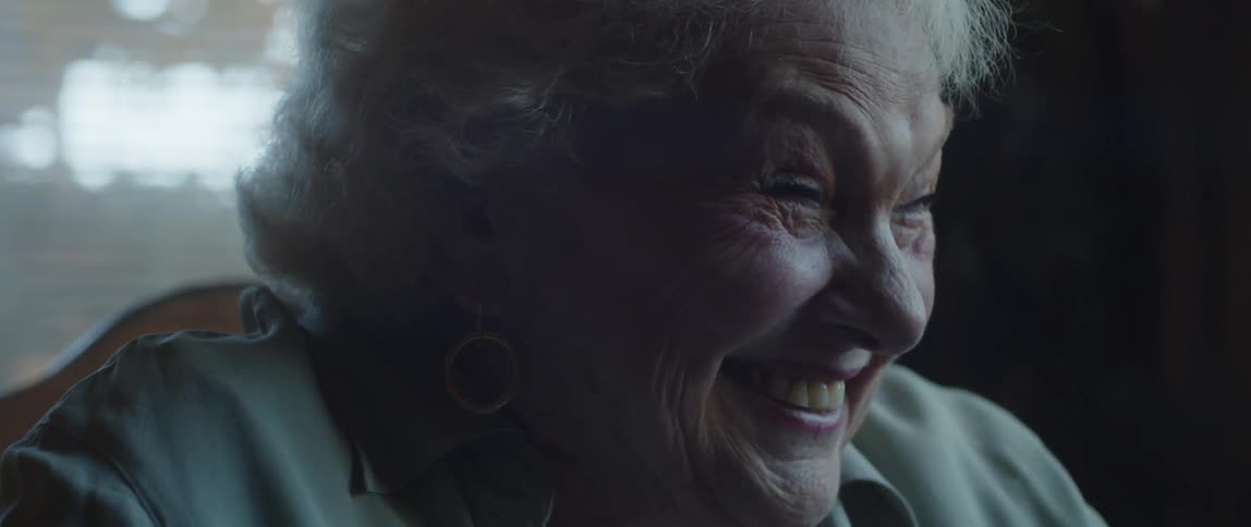 Side portrait of an elderly woman laughing