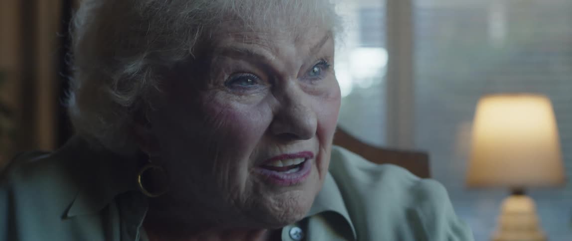 Close up of an elderly woman having a conversation at home