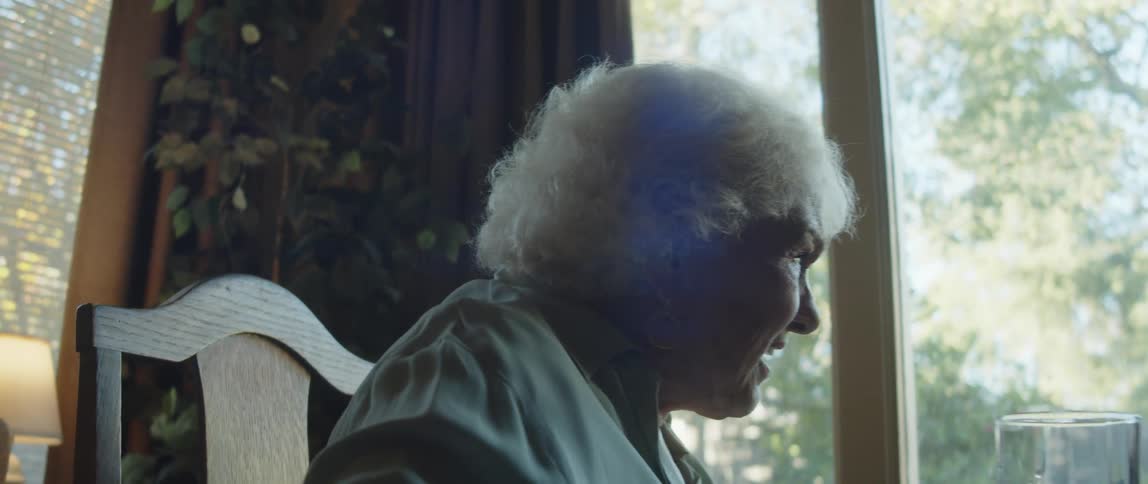 Close up of an elderly woman having a conversation at home