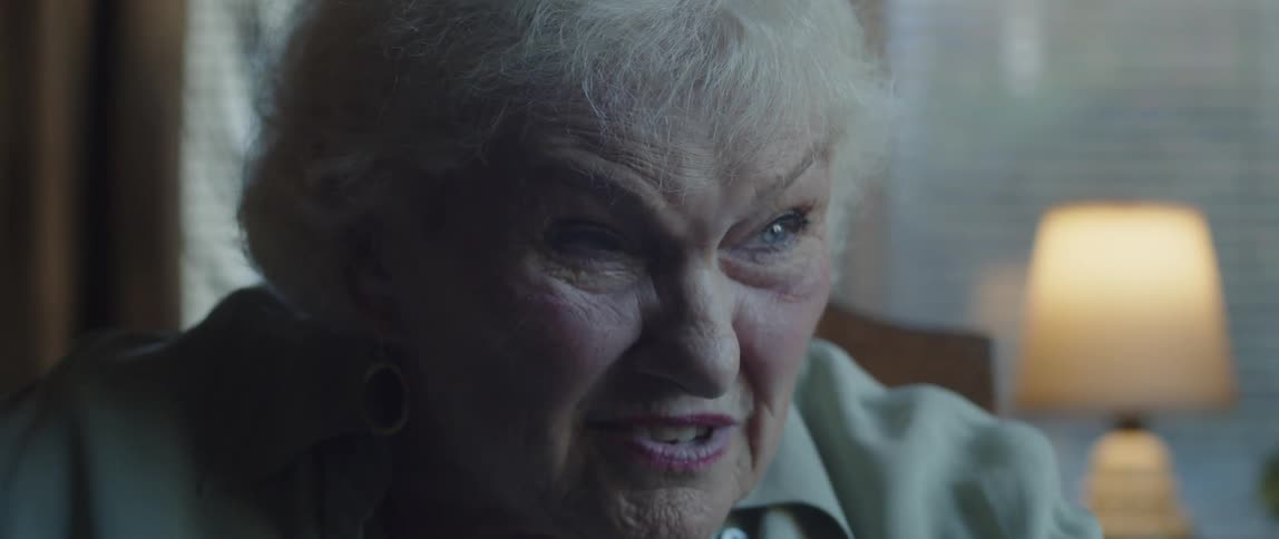 Portrait of an elderly woman sitting and smiling talking