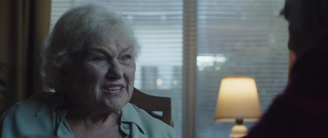 Close up of a happy elderly woman having a conversation at home