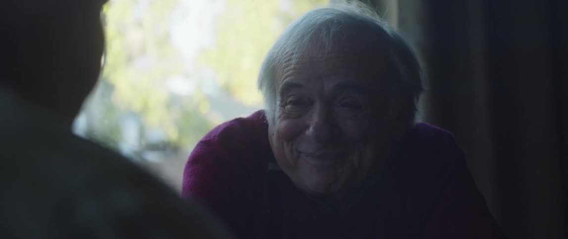 A man and woman talk and laugh
