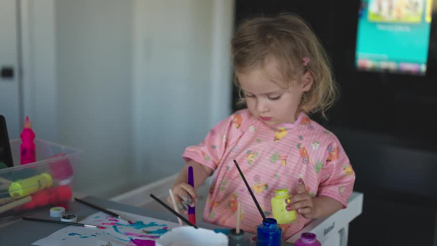 Girl playing with brush and paint