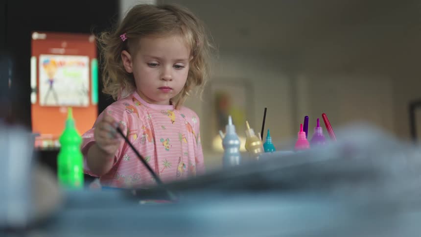 Little girl playing with paint brush