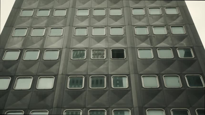 Facade of a modern building with a repeating pattern of square windows