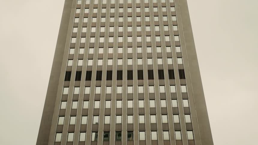 Skyscrapers with windows patterned against a cloudy sky