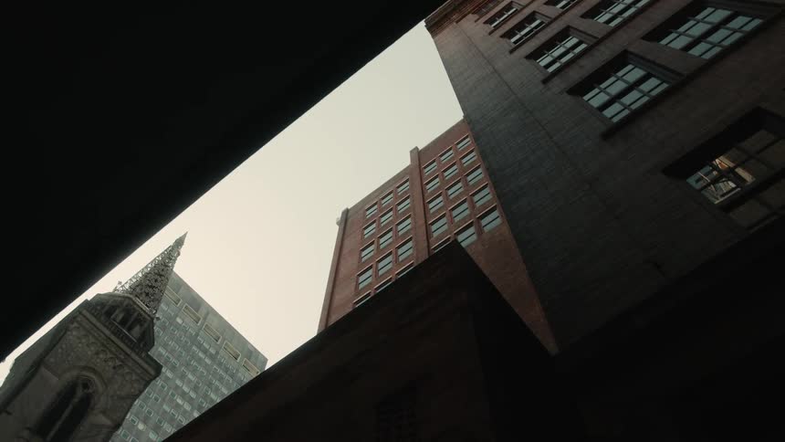Upward view of a large buildings in a metropolis on a cloudy day