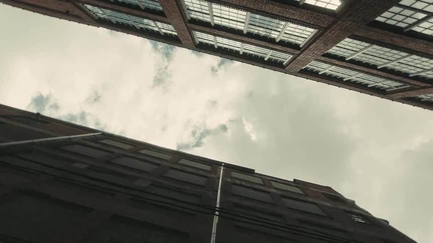 View of two buildings looking upwards toward the sky in a downtown metropolitan area