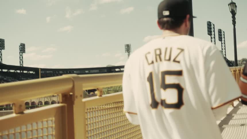 Back view of two men wearing cheer uniforms entering a stadium