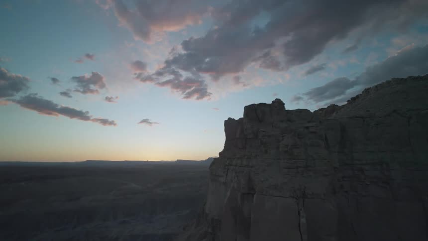 A large mountain reveals it has deep cracks and fissures on one of its cliffs