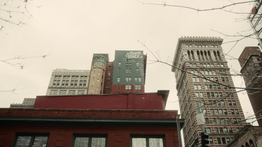 Upward view of large buildings on a cloudy day