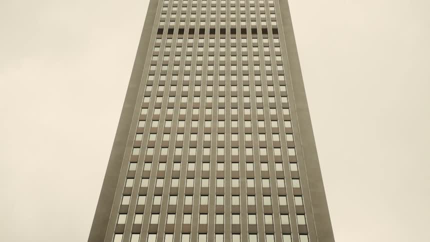 A large city building reaches high up into the sky