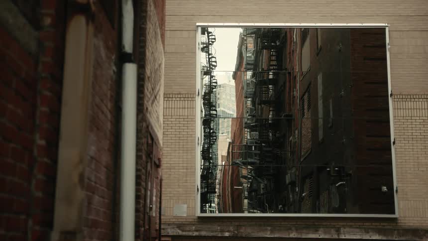 Digital screen that reflects an alley with residential buildings