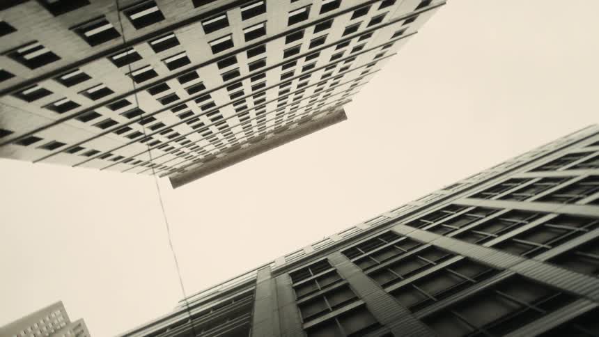 The clear sky is visible between two very tall buildings