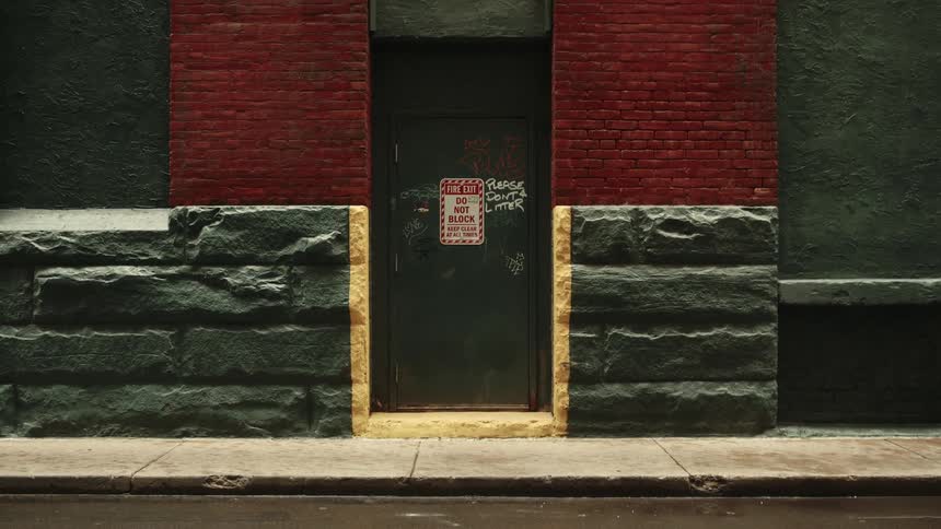 Message asking people not to litter is written on a building door that has a do not block sign