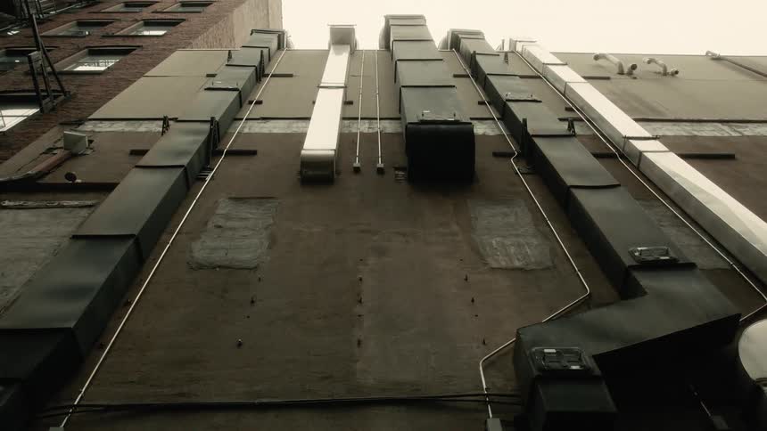 Side of a residential building with pipes