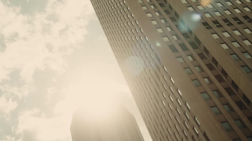 Two large skyscrapers under a cloudy sky in the city