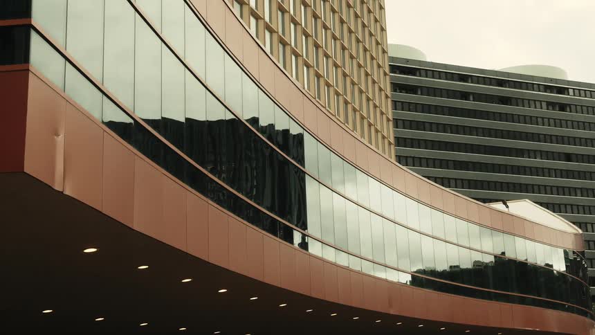 Reflective panel of building reflects other nearby buildings