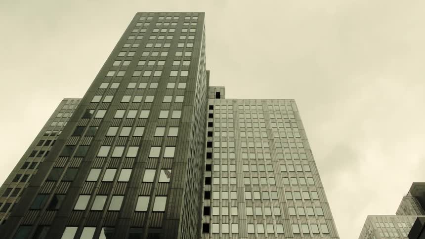Imposing skyscraper with multiple windows under a cloudy sky