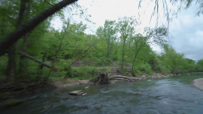 A picturesque river stream winds around in the forest in Arkansas