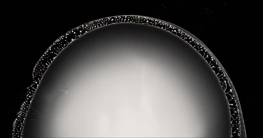 Closeup of a liquid expanding with condensed water droplets