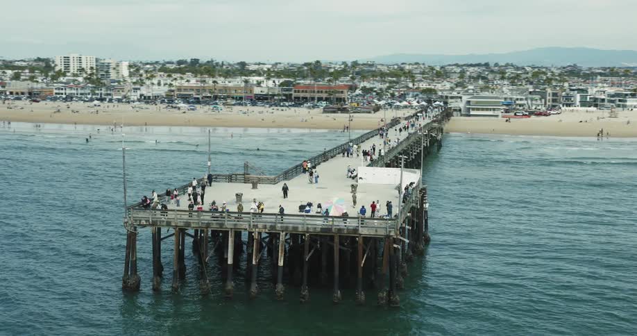 People walk on the pier on the shore