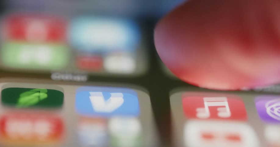 Extreme closeup of a finger touching and moving an iphone
