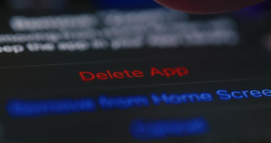 Person makes selection on touchscreen to delete an app