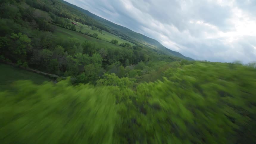 Forests and ponds and a river give way to a rural farming area in Arkansas