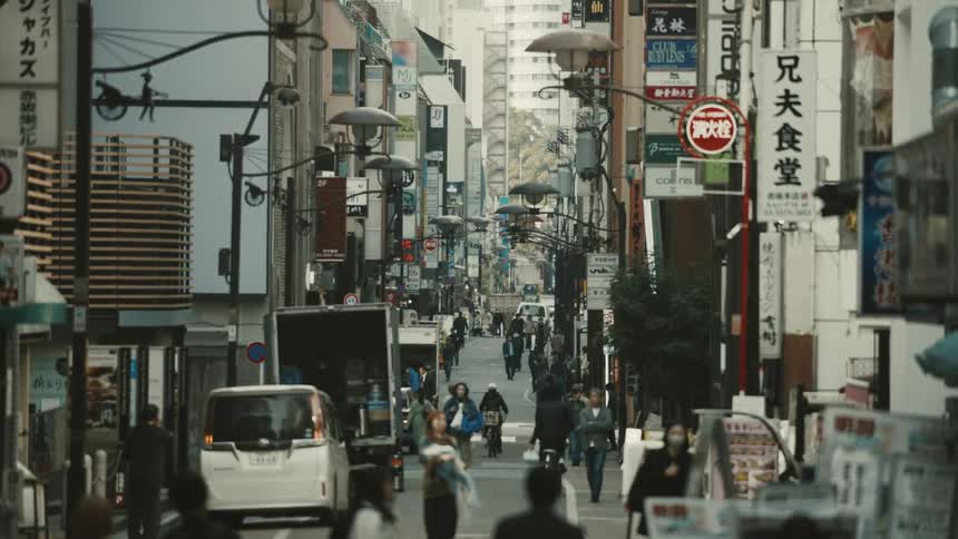 The road in the city is full of walking people