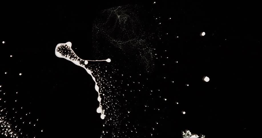 White abstract fluid in microscopic view against a black background
