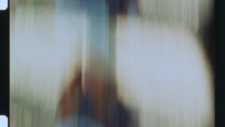Blurred footage of people outdoors caught on vintage film
