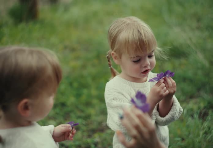 A mother shows her daughters flowers