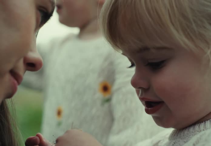 A mother enjoys her two daughters in nature