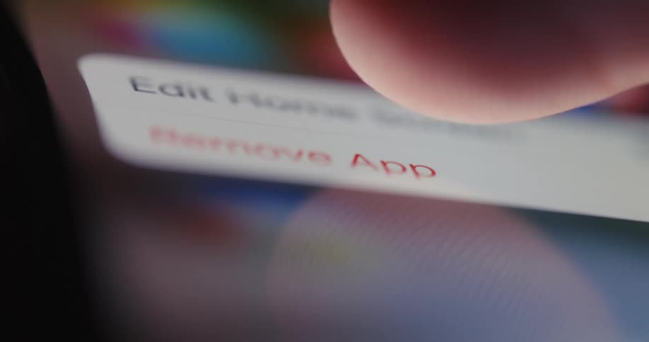 Extreme closeup of a persons finger pressing the iphone screen