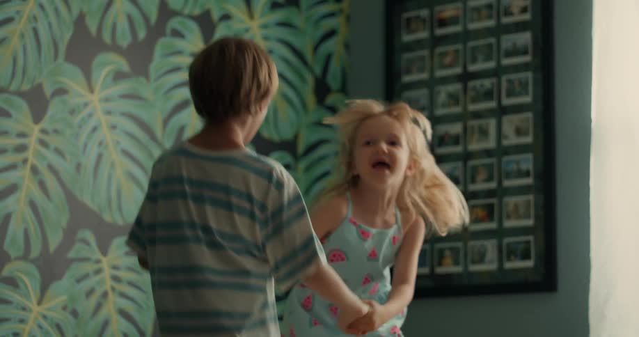 Little boy and girl holding hands jumping and smiling