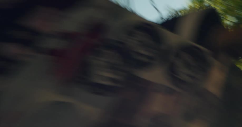 Slow motion shot from below of a skateboarder performing a jump